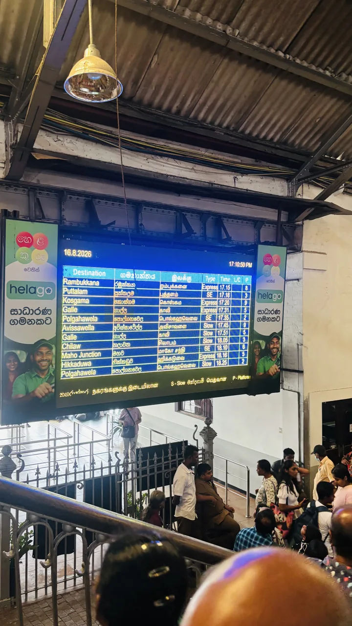 LCD departure board showing destinations, times and platforms at Colombo Fort