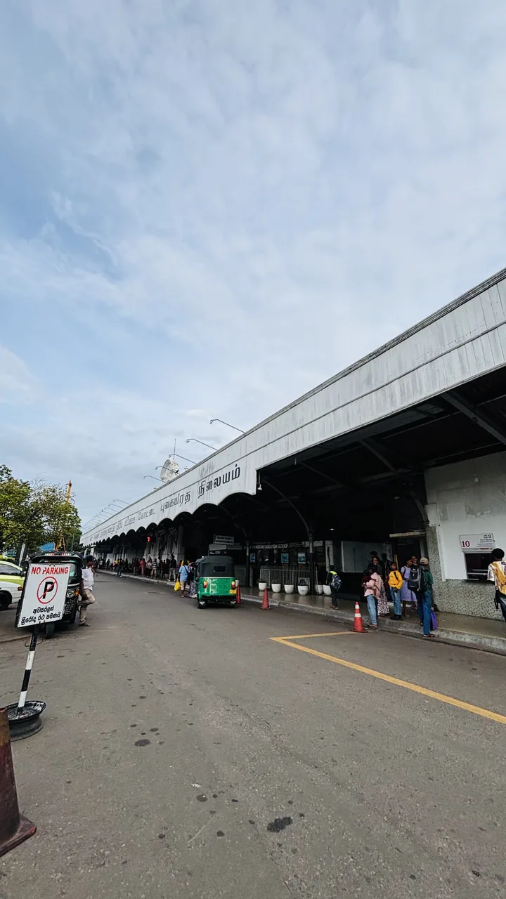 Street entrance of Colombo Fort Railway Station with a tuk-tuk passing