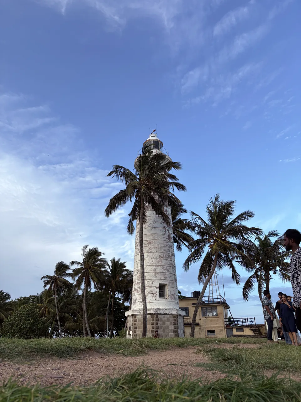 Galle Lighthouse surrounded by palm trees inside Galle Fort