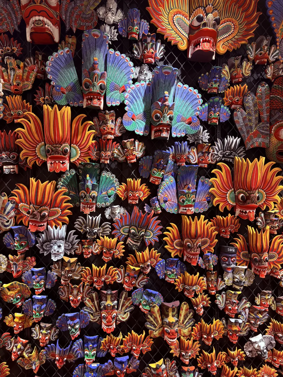 Colorful traditional Sri Lankan masks on display in Hiriketiya