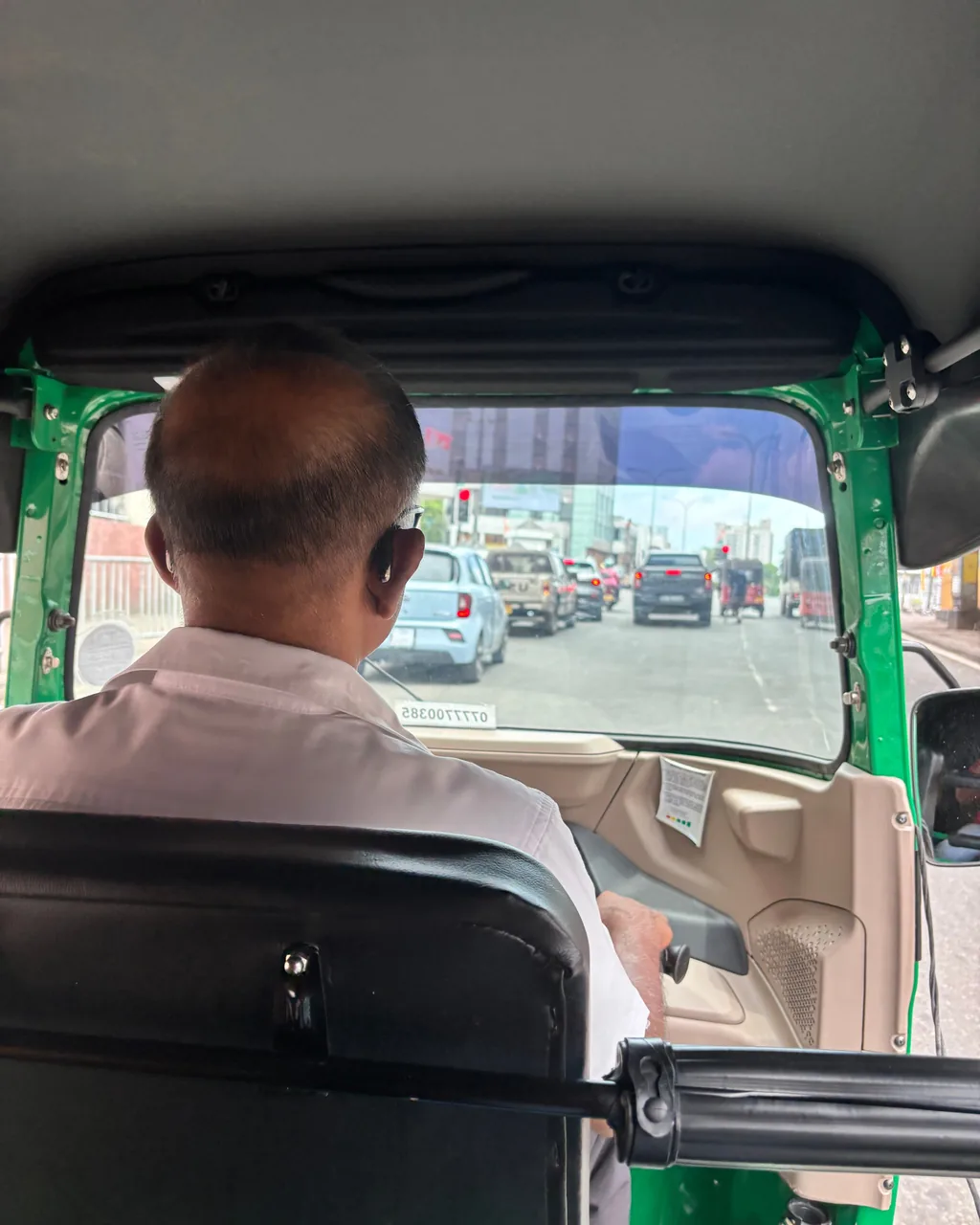 Riding in a tuk-tuk booked through a ride-hailing app in Colombo