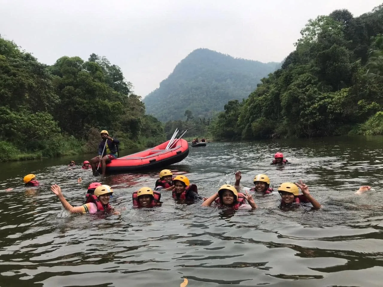 Rafters floating and swimming in a calm stretch of the Kelani River