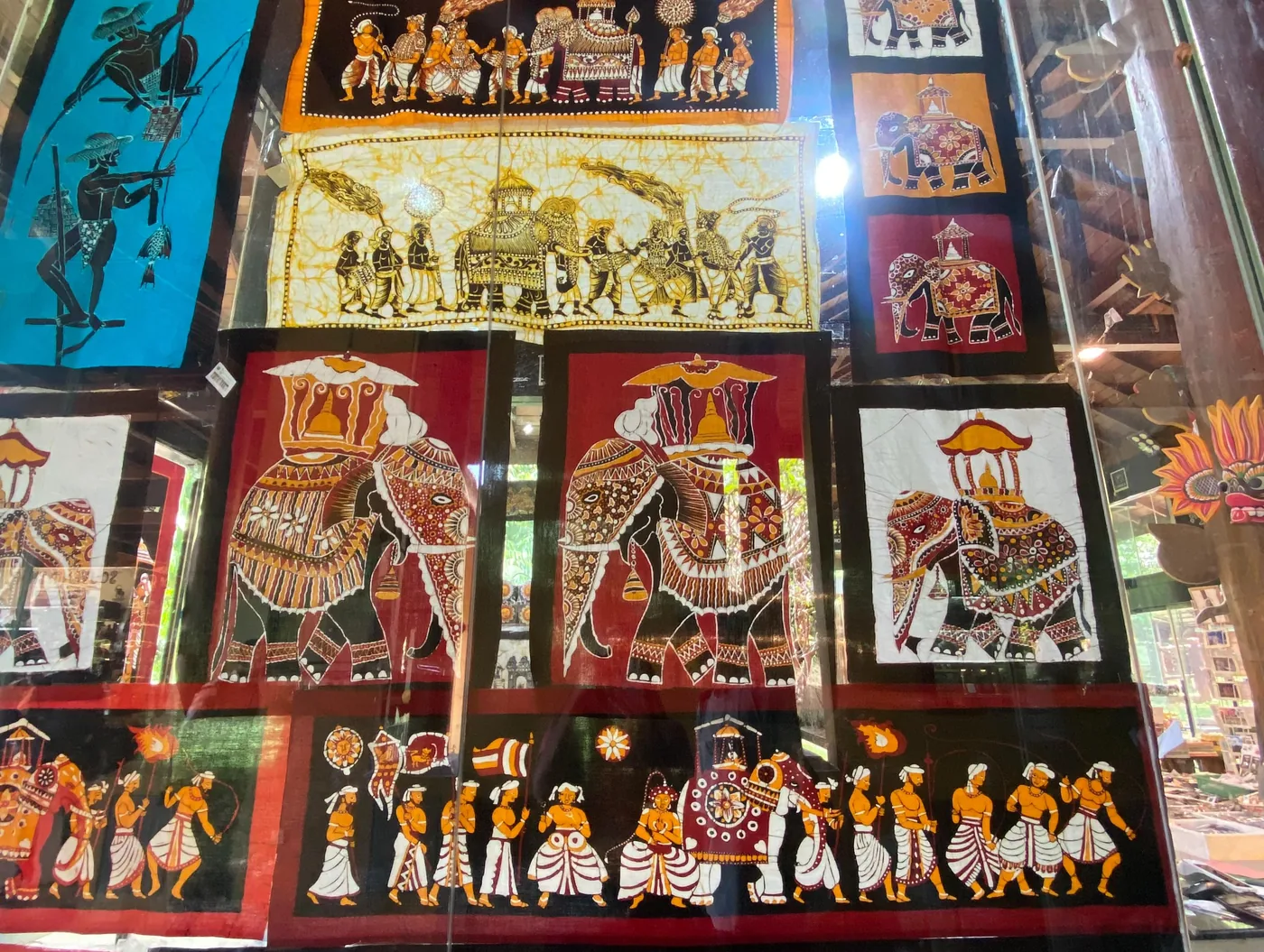 Traditional Sri Lankan batik artwork depicting decorated tusker elephants in a temple procession
