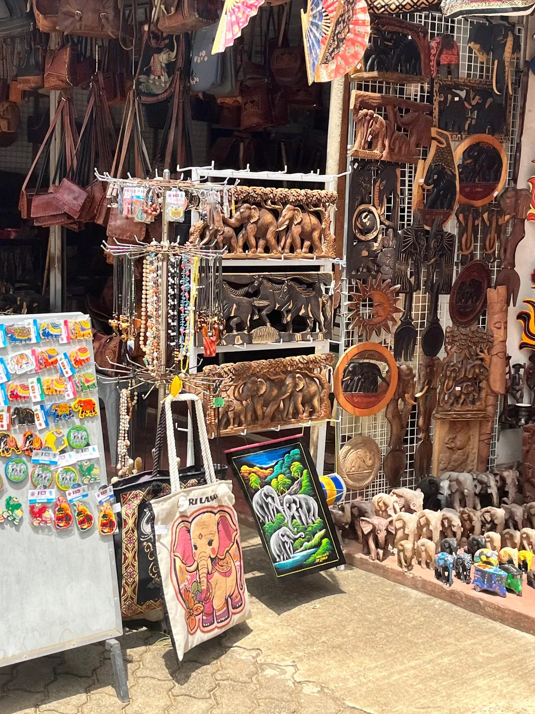 Souvenir stall selling wooden elephant carvings and handicrafts near Pinnawala