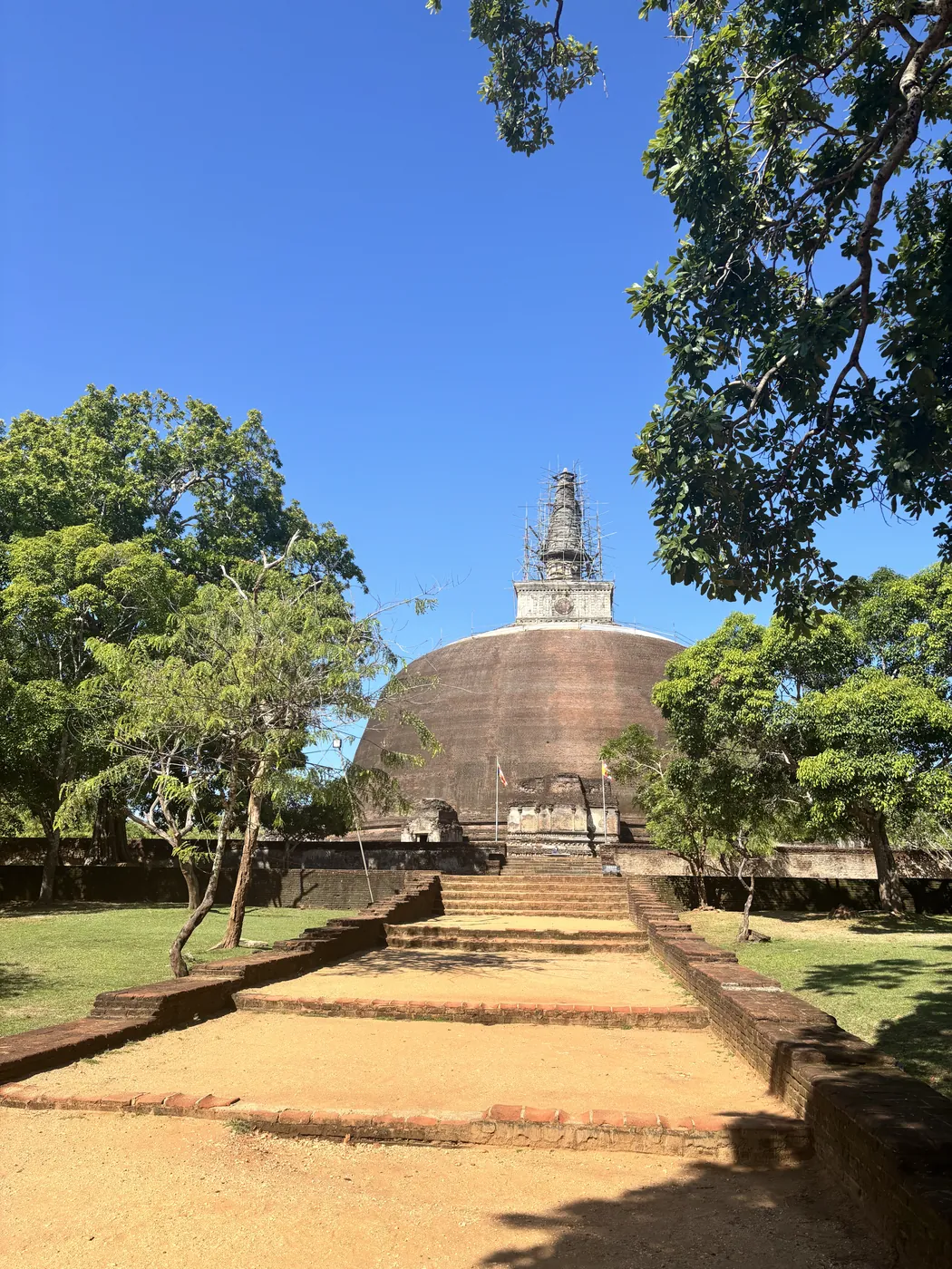 The large brick stupa of Rankoth Vehera framed by trees in Polonnaruwa