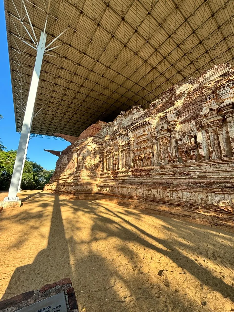 Weathered carved exterior wall of the Thivanka Pilgrimage House in Polonnaruwa